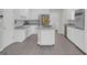 Spacious eat-in kitchen with grey counters, white cabinets, and stainless appliances at 121 Tamerlane, Peachtree City, GA 30269