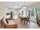 Bright kitchen with white cabinets, island cooktop, stainless steel refrigerator, and seating at the wooden table at 121 Tamerlane, Peachtree City, GA 30269