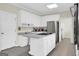 Bright kitchen with white cabinets, long countertops, island cooktop, stainless steel refrigerator at 121 Tamerlane, Peachtree City, GA 30269