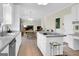 Bright kitchen with white cabinets, long countertops, island cooktop, and stainless steel appliances at 121 Tamerlane, Peachtree City, GA 30269