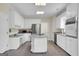 Spacious kitchen features white cabinetry, stainless steel appliances, and center island at 121 Tamerlane, Peachtree City, GA 30269