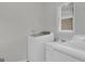 Laundry room featuring washing machine, sink, and storage at 121 Tamerlane, Peachtree City, GA 30269