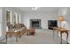 Bright living room featuring a fireplace with green tile and neutral furnishings at 121 Tamerlane, Peachtree City, GA 30269
