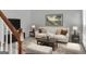 A furnished living room with neutral walls, carpeting, and a window with natural light at 121 Tamerlane, Peachtree City, GA 30269