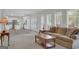 Open-concept living room flows into the kitchen area with natural light at 121 Tamerlane, Peachtree City, GA 30269