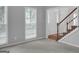 An open concept living space with ample natural light, plush carpet, and staircase at 121 Tamerlane, Peachtree City, GA 30269