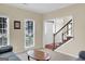 Bright living room with large windows, staircase access, and hardwood floors at 121 Tamerlane, Peachtree City, GA 30269