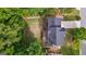 Aerial view showcases the backyard with a deck, stone patio, and surrounding landscaping at 126 Ardenlee Dr, Peachtree City, GA 30269