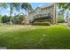 Large green backyard showcasing a wooden deck with stairs and a patio, ideal for outdoor activities and relaxation at 126 Ardenlee Dr, Peachtree City, GA 30269