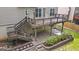 View of a two-story home's backyard with a beautiful deck, patio and an outdoor swing at 126 Ardenlee Dr, Peachtree City, GA 30269
