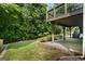 Spacious backyard featuring a stone patio, swing, lush greenery, and an inviting outdoor space for relaxation at 126 Ardenlee Dr, Peachtree City, GA 30269