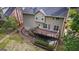 View of a two-story home's backyard with a beautiful deck, patio and an outdoor swing at 126 Ardenlee Dr, Peachtree City, GA 30269