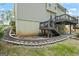 Well-maintained backyard featuring a brick retaining wall and stair access to the house, landscaped for aesthetic appeal at 126 Ardenlee Dr, Peachtree City, GA 30269