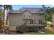 View of a two-story home's backyard with a beautiful deck, patio and an outdoor swing at 126 Ardenlee Dr, Peachtree City, GA 30269
