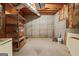 Unfinished basement with exposed ceiling, and a sturdy metal shelving unit at 126 Ardenlee Dr, Peachtree City, GA 30269