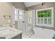 Modern bathroom with glass shower, soaking tub, granite vanity, and natural light at 126 Ardenlee Dr, Peachtree City, GA 30269