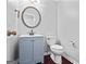 Powder room featuring a blue vanity, round mirror and modern fixtures at 126 Ardenlee Dr, Peachtree City, GA 30269