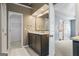 Bathroom vanity with granite countertop, dark cabinets, and views to a closet and doorway at 126 Ardenlee Dr, Peachtree City, GA 30269