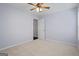 Bedroom with light purple walls, ceiling fan, neutral carpet, and white door to ensuite at 126 Ardenlee Dr, Peachtree City, GA 30269