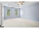 Bright, spacious bedroom with two windows and neutral carpeting at 126 Ardenlee Dr, Peachtree City, GA 30269
