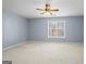Spacious bedroom features a neutral carpet and ceiling fan for added comfort at 126 Ardenlee Dr, Peachtree City, GA 30269