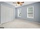 Comfortable bedroom with carpet, two windows, closet, and soft blue walls at 126 Ardenlee Dr, Peachtree City, GA 30269