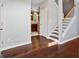 Elegant entryway featuring hardwood floors, staircase, and a glimpse of the kitchen at 126 Ardenlee Dr, Peachtree City, GA 30269