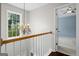 Upstairs hallway with a window, chandelier and hardwood flooring at 126 Ardenlee Dr, Peachtree City, GA 30269