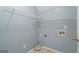 Bright laundry room featuring white wire shelving and tile flooring for easy maintenance at 126 Ardenlee Dr, Peachtree City, GA 30269