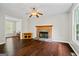 Inviting living room features a cozy fireplace, ceiling fan and hardwood floors at 126 Ardenlee Dr, Peachtree City, GA 30269