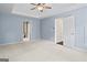 Spacious main bedroom featuring a trey ceiling, ceiling fan, neutral carpet, and ensuite access at 126 Ardenlee Dr, Peachtree City, GA 30269