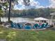 Lakeside backyard featuring a stone fire pit and plenty of Adirondack chairs for entertaining at 22 Waters Bridge Cir, Covington, GA 30014