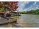 Exterior shot of a well-kept backyard with a concrete boat ramp and covered dock for lakeside enjoyment at 22 Waters Bridge Cir, Covington, GA 30014