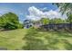 Exterior shot of a lush backyard featuring a large, verdant lawn with a house in the background at 22 Waters Bridge Cir, Covington, GA 30014