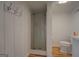 Bathroom with white toilet, glass shower, and hardwood floors at 22 Waters Bridge Cir, Covington, GA 30014