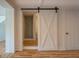 Bathroom with white barn door, glass shower, and neutral decor at 22 Waters Bridge Cir, Covington, GA 30014