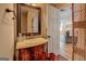 Elegant bathroom with a vintage-style vanity, mirror, and a glimpse into the living room at 22 Waters Bridge Cir, Covington, GA 30014