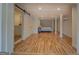 Spacious bedroom area with hardwood floors and a sliding barn door to bathroom at 22 Waters Bridge Cir, Covington, GA 30014