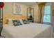 Cozy bedroom featuring a wooden headboard, geometric throw pillows, and natural light from the window at 22 Waters Bridge Cir, Covington, GA 30014
