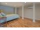 Comfortable bedroom with hardwood floors, bright lighting, and neutral decor at 22 Waters Bridge Cir, Covington, GA 30014