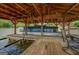 Covered boat dock housing a well-maintained boat, equipped with a boat lift and surrounded by waterfront amenities at 22 Waters Bridge Cir, Covington, GA 30014