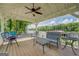 Charming covered porch with comfortable seating and a ceiling fan, perfect for relaxing outdoors at 22 Waters Bridge Cir, Covington, GA 30014