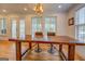 Dining room featuring a rustic table, seating for four, lots of windows, and natural light at 22 Waters Bridge Cir, Covington, GA 30014