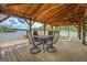 Covered boat dock with outdoor dining table and chairs, perfect for entertaining and enjoying waterfront views at 22 Waters Bridge Cir, Covington, GA 30014