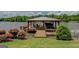 Exterior shot of a covered dock with a boat slip, seating, and lush landscaping on the lake at 22 Waters Bridge Cir, Covington, GA 30014