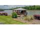 Exterior shot of a covered boat dock with seating, boat slip, and surrounding lush lawn and landscaping at 22 Waters Bridge Cir, Covington, GA 30014