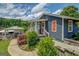 Exterior shot of the house from the back featuring a lush green lawn and covered porch with steps at 22 Waters Bridge Cir, Covington, GA 30014