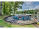 Lakeside backyard features a cozy fire pit area and covered porch for relaxing with stunning views at 22 Waters Bridge Cir, Covington, GA 30014
