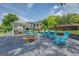 Inviting outdoor firepit area with Adirondack chairs for relaxing, with the home and covered patio visible in the background at 22 Waters Bridge Cir, Covington, GA 30014