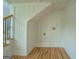 Hallway with under stair storage and hardwood floors at 22 Waters Bridge Cir, Covington, GA 30014